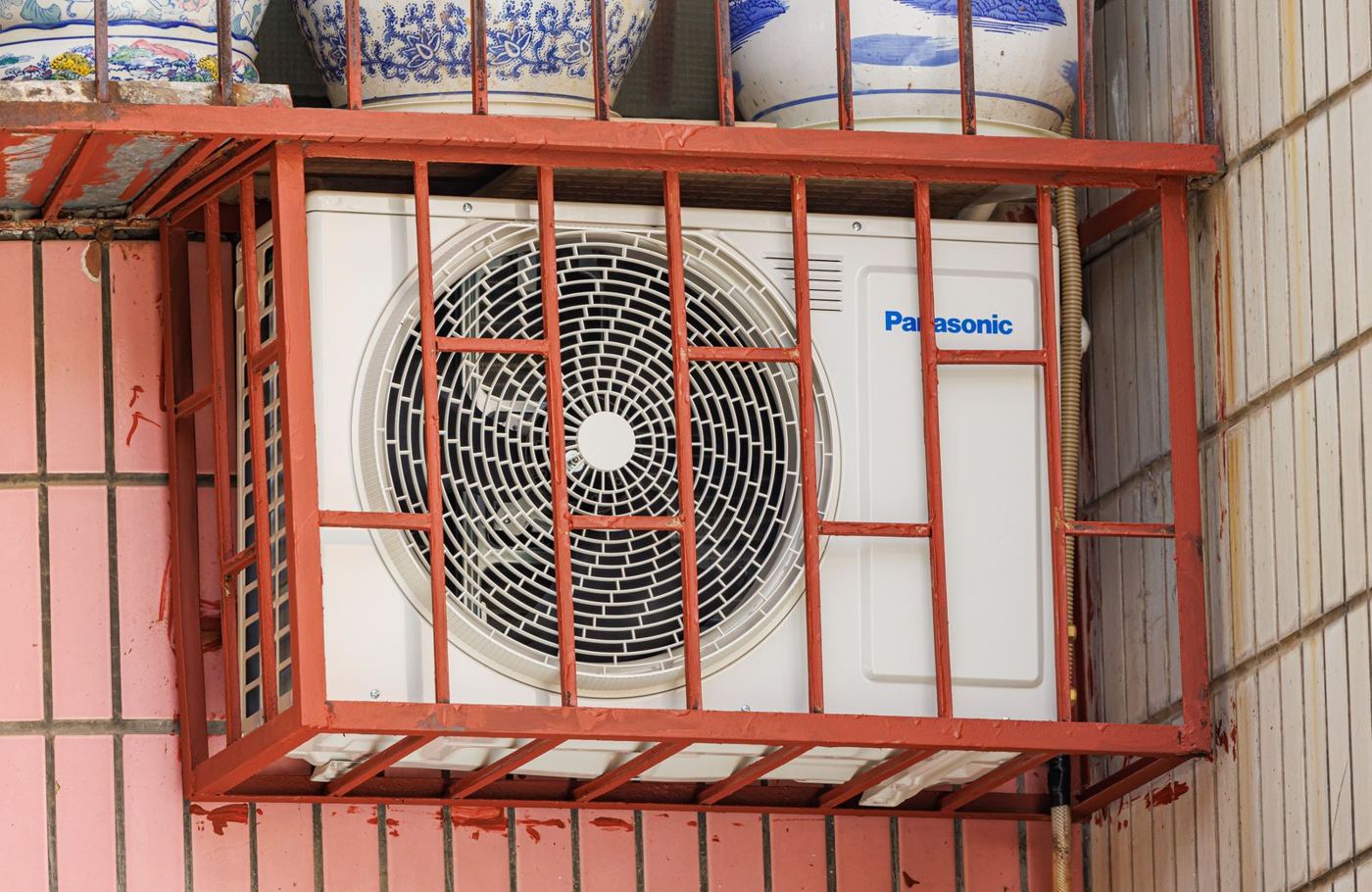 Outdoor condenser unit in a protective cage